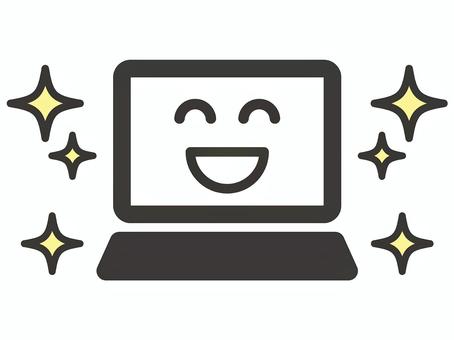 新品のパソコンの画面に笑顔の表情が映し出されている画像